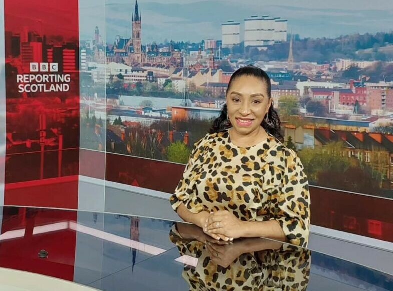 Dr Yalinu Poya Gow at the BBC Scotland News Reporting desk.